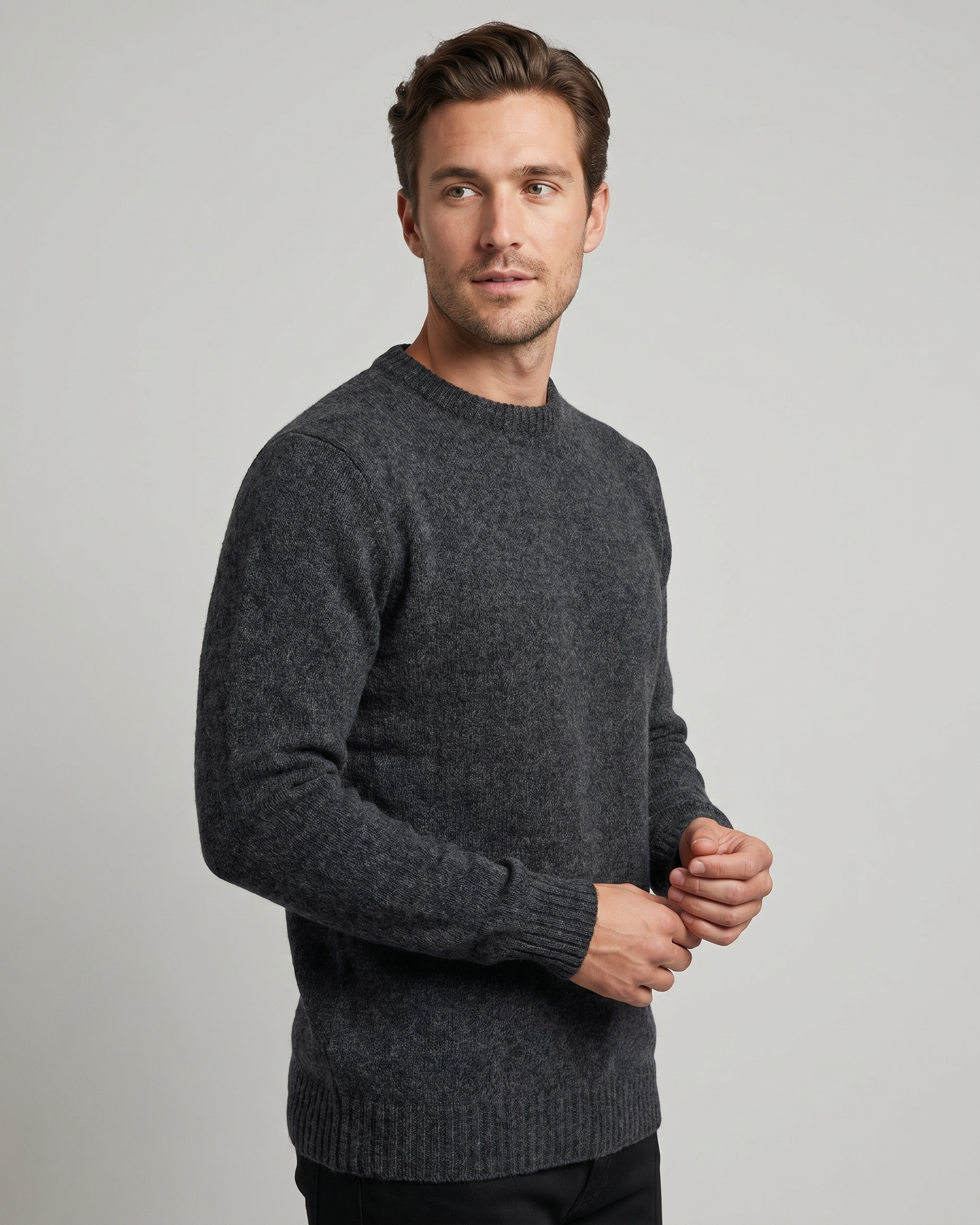 Man wearing a dark gray sweater against a plain background