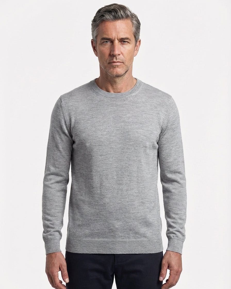 Man wearing a gray sweater on a white background