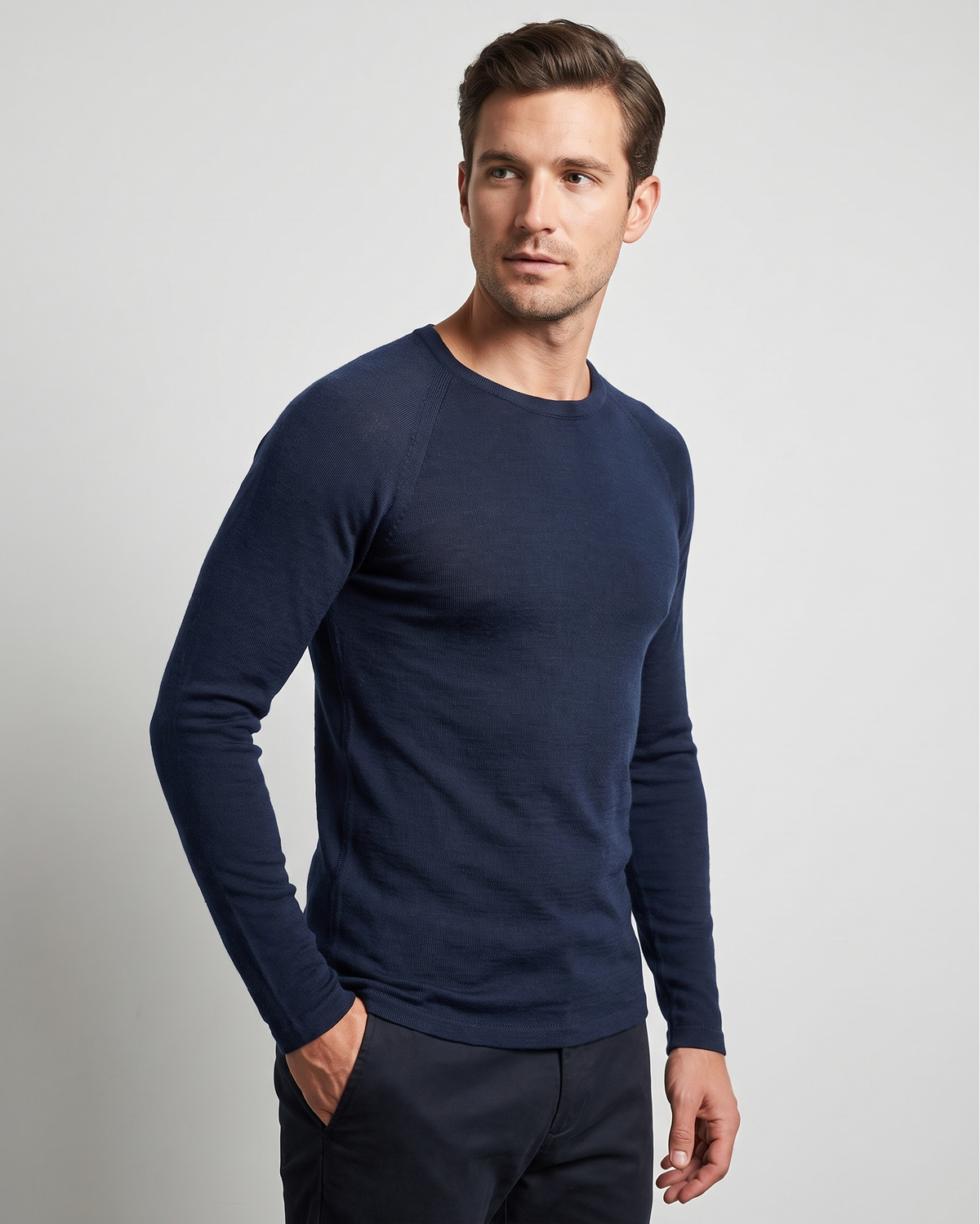 Man wearing a navy blue long-sleeve thermal against a light gray background
