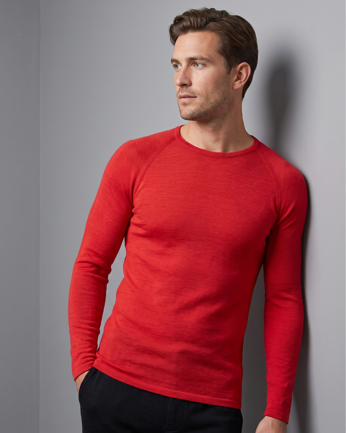 Man wearing a red long-sleeve thermal against a gray background