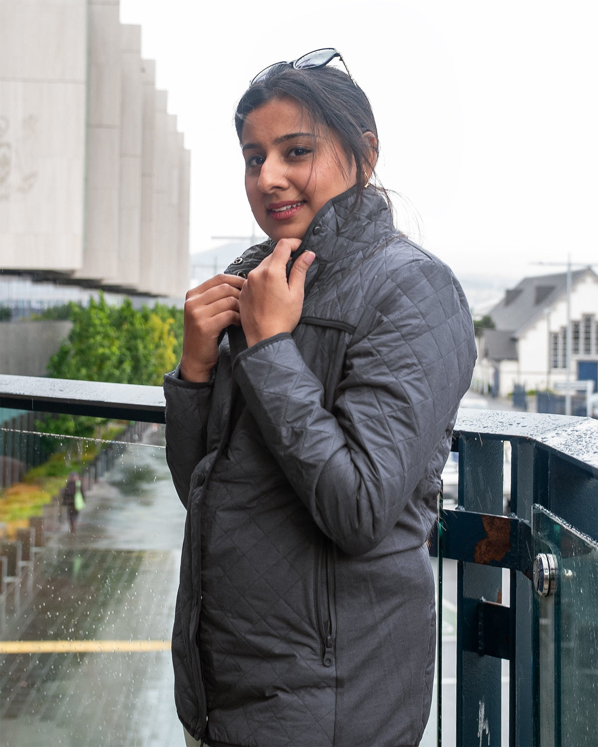 Blonde women wearing a long tan coloured jacket.