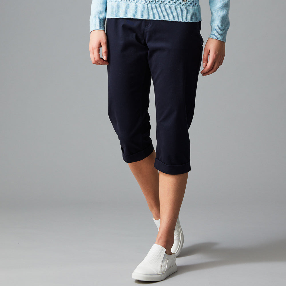 Women wearing light blue long sleeve and navy blue 3/4 length pants.