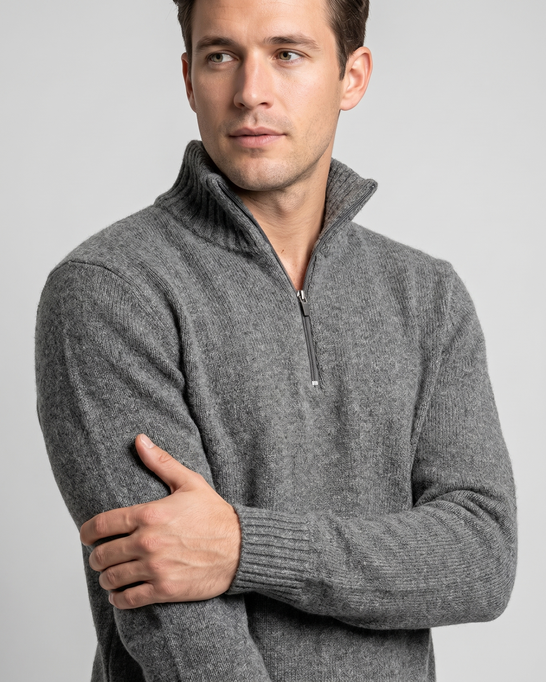 Man wearing a gray quarter-zip sweater on a light gray background
