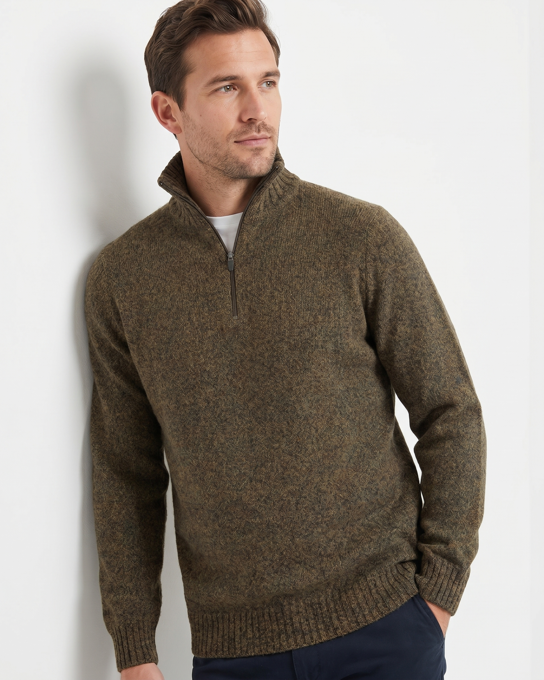 Man wearing a brown quarter-zip sweater against a plain background