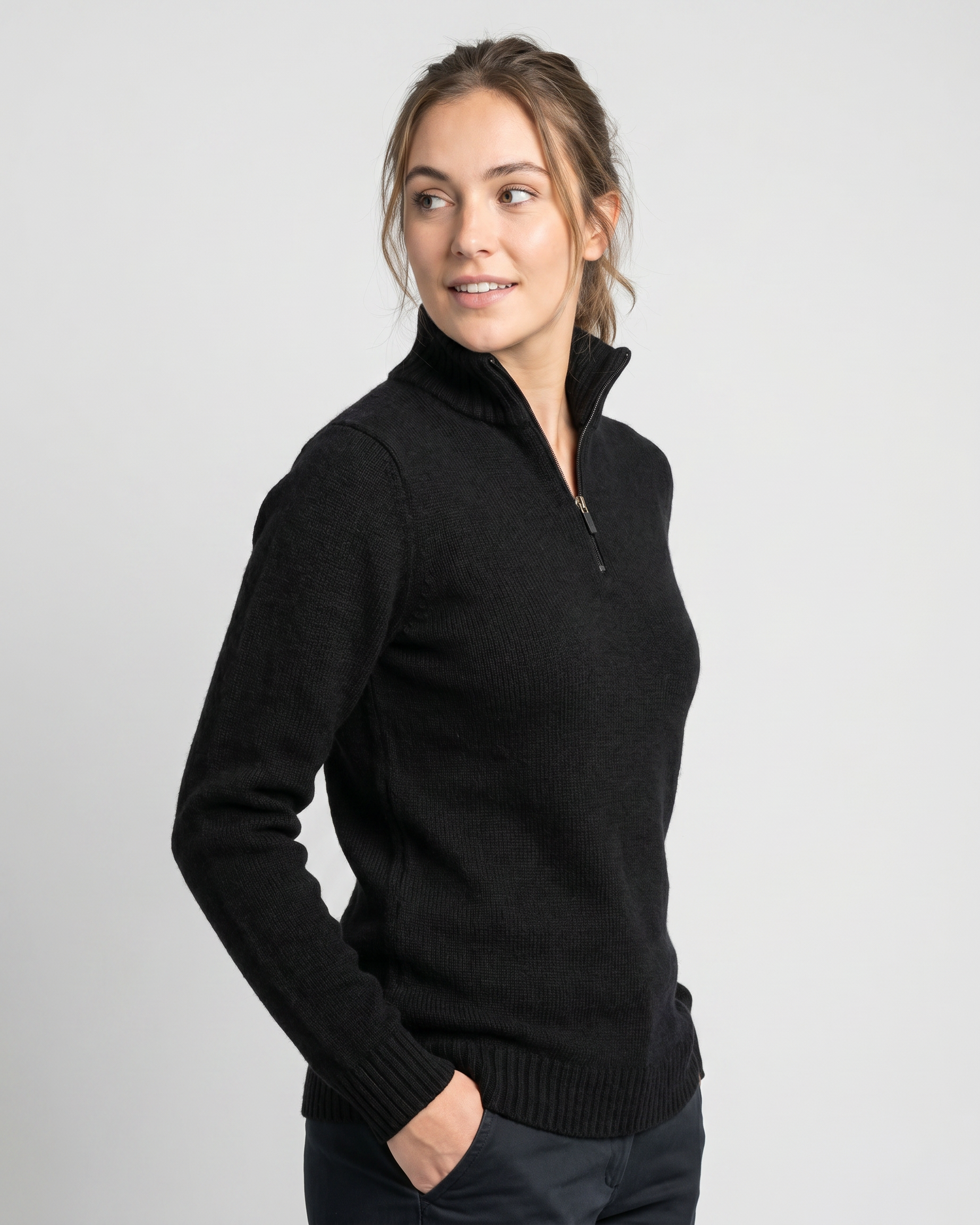 Woman wearing a black sweater against a light gray background