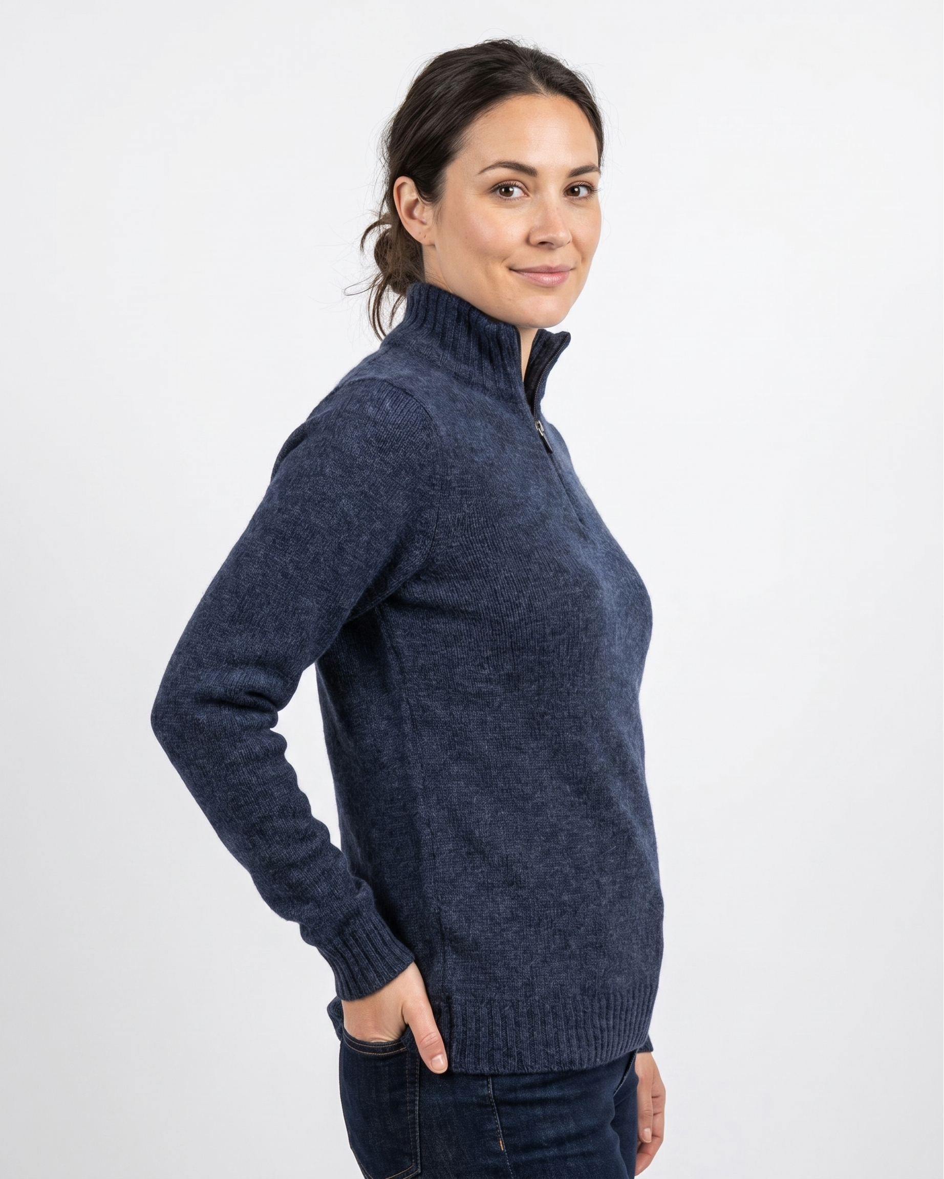 Woman wearing a navy handel sweater against a white background