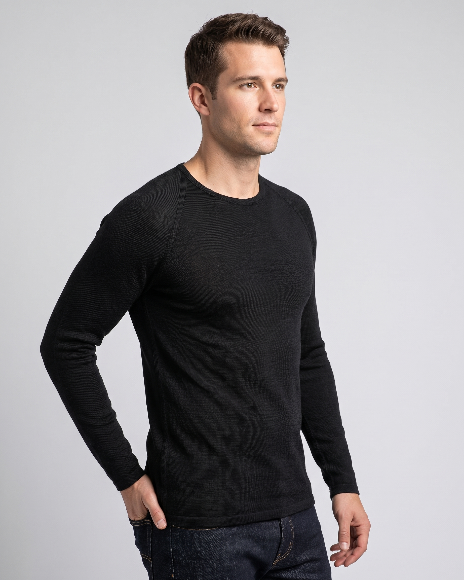 Man wearing a black long-sleeve thermal against a gray background