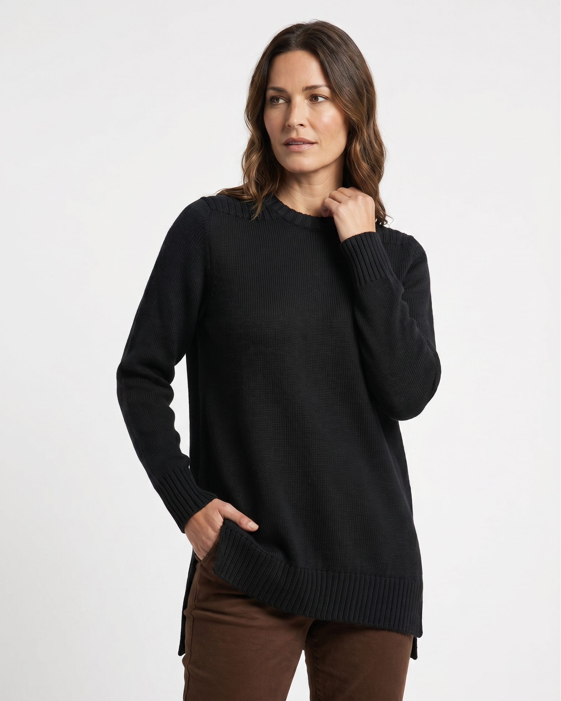 Woman wearing a black tunic sweater on a white background